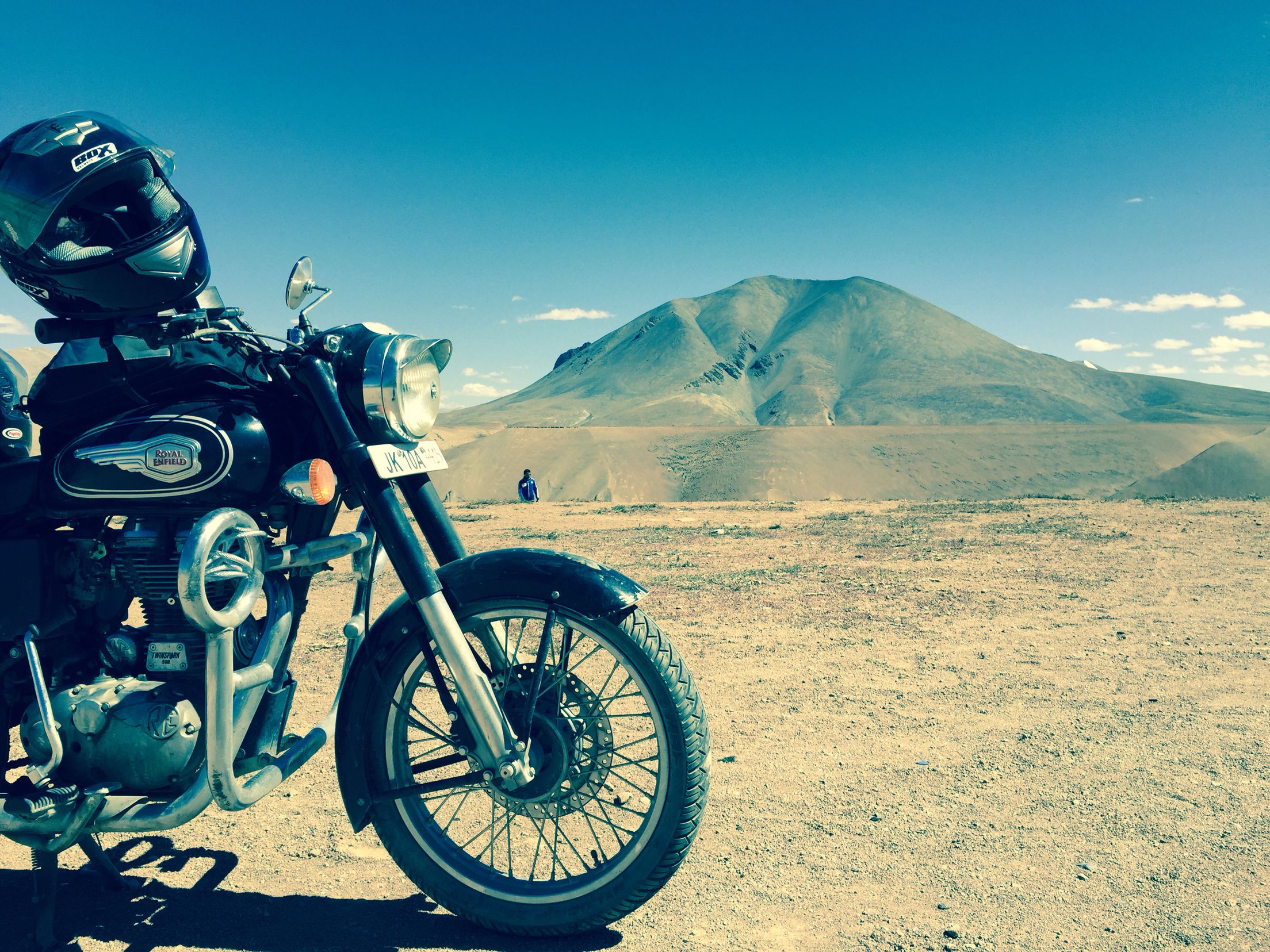 Rider on a Royal Enfield Bullet traveling through Ladakh’s scenic mountain roads