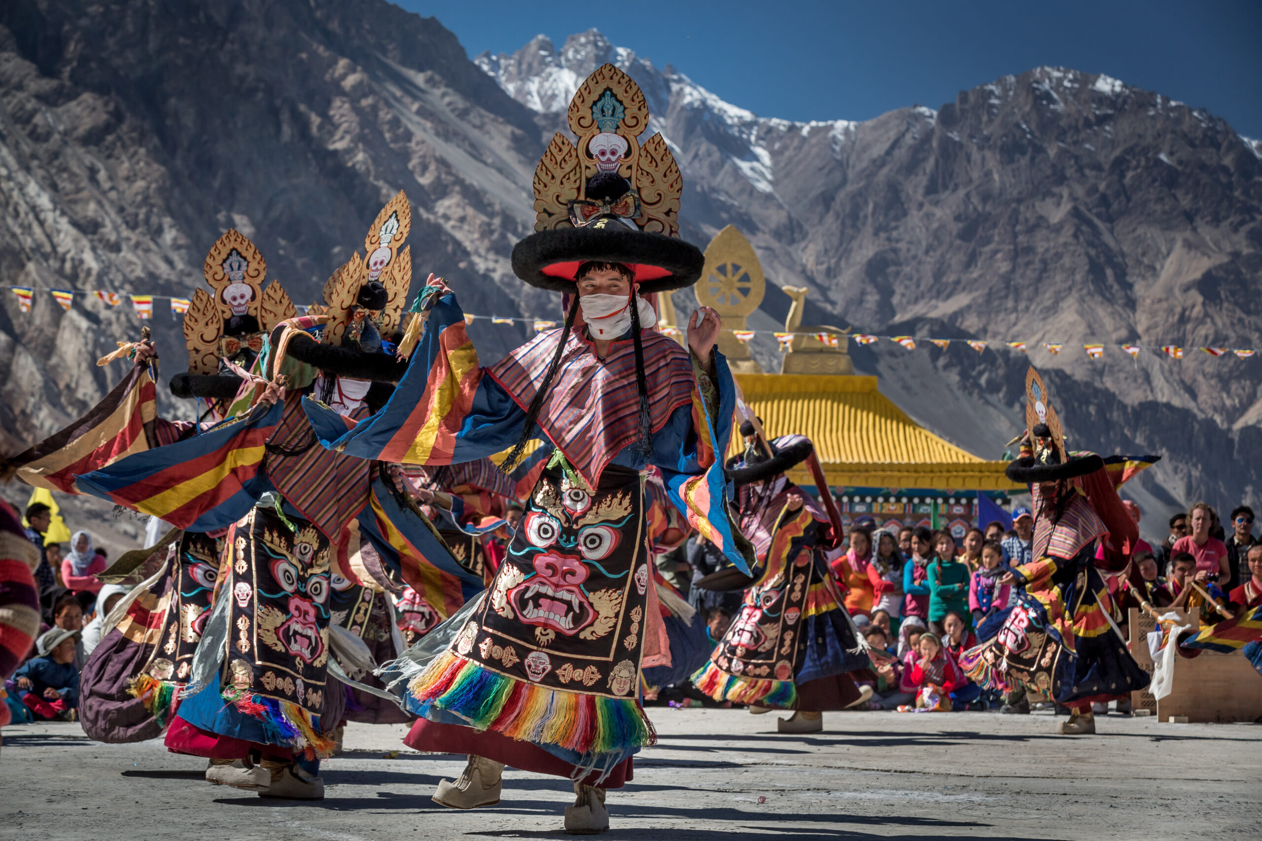 Ladakhi performers in traditional costumes showcasing a folk dance