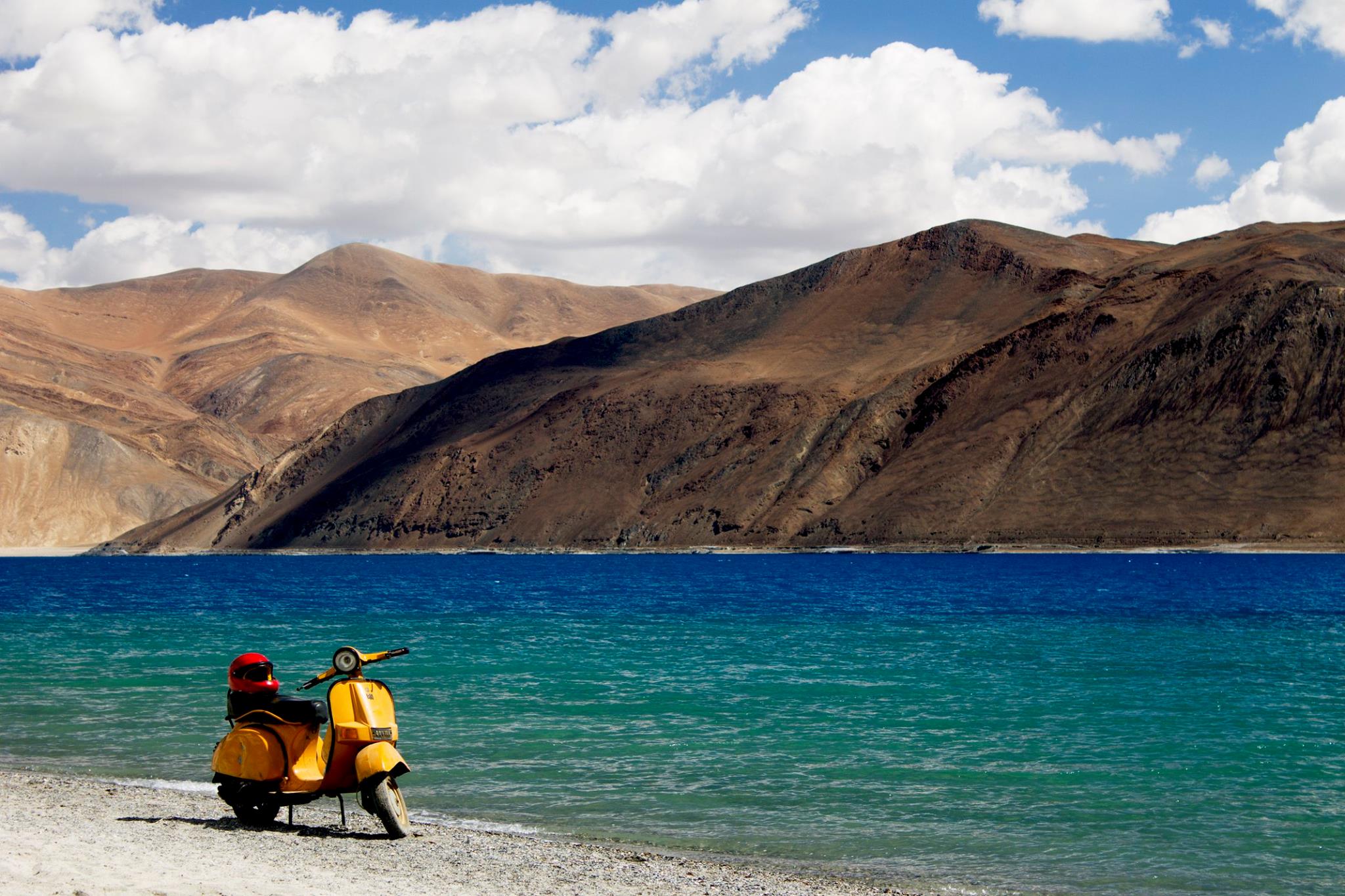 Pangong Lake in Ladakh with crystal blue water and mountains in the background