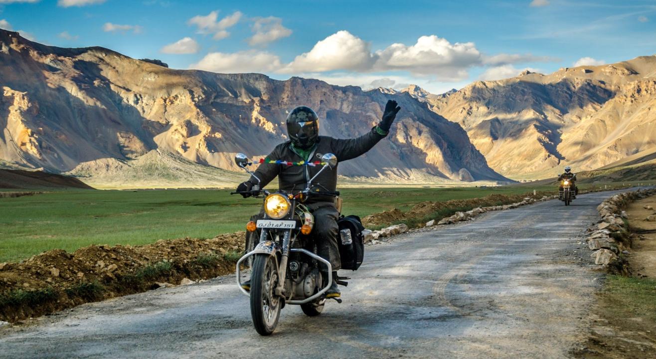 Rider on a Royal Enfield Bullet traveling through Ladakh’s scenic mountain roads