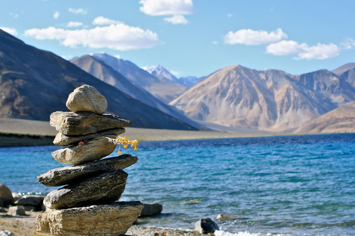 Pangong Lake in Ladakh with crystal blue water and mountains in the background