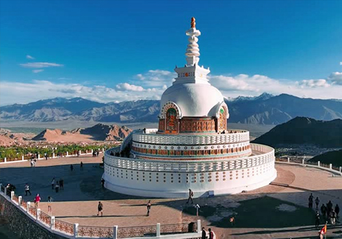 Shanti Stupa in Leh Ladakh with white dome against mountain backdrop